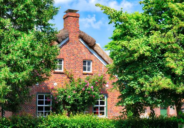 A new build brick house with a garden.
